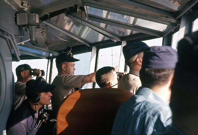 S19640303010.JPG - CAPT RUDDEN (FAR LEFT)DIRECTING BRIDGE WATCH